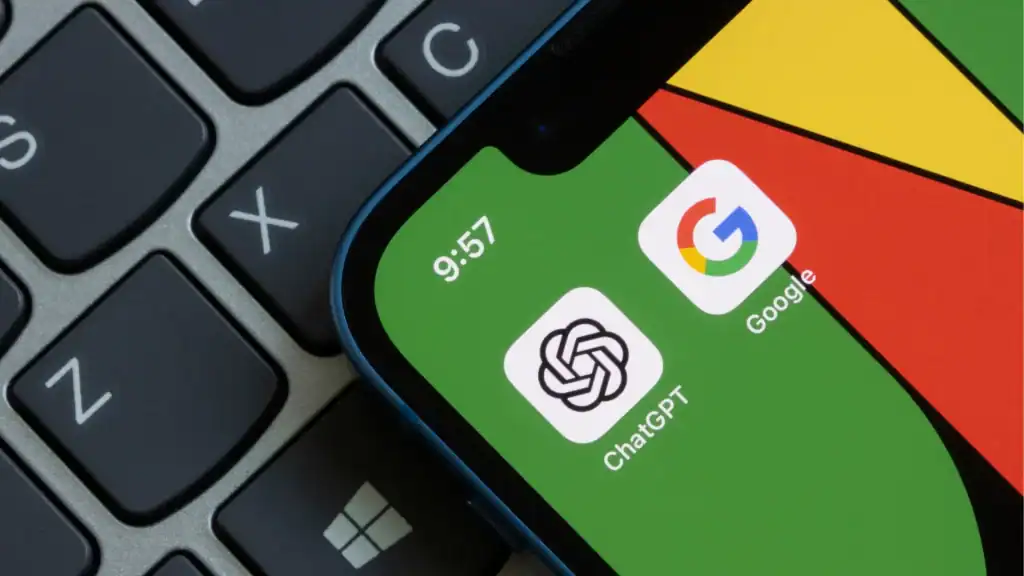 A smartphone showing the ChatGPT and Google app icons on its home screen, placed on top of a laptop keyboard.