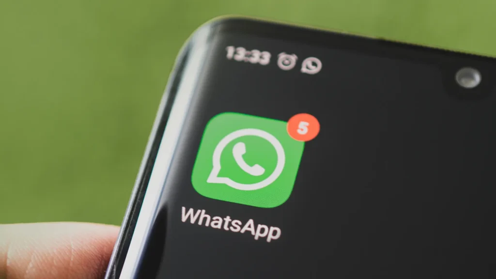 Close-up of a smartphone showing the WhatsApp icon with message notifications, symbolising new Google Ads customer support integration via WhatsApp.