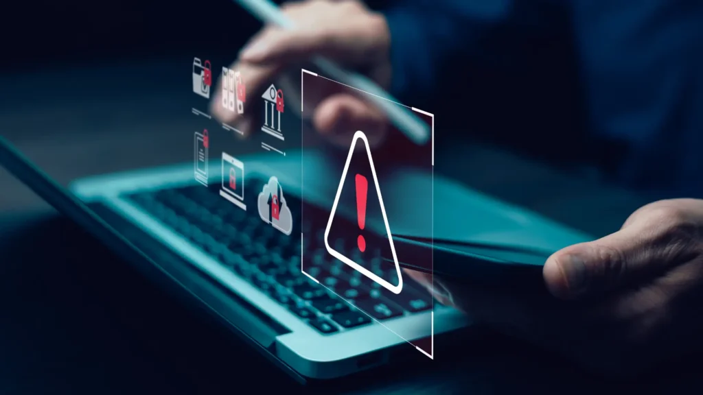 Cybersecurity warning symbol over a laptop screen, representing online threats and SEO poisoning risks.