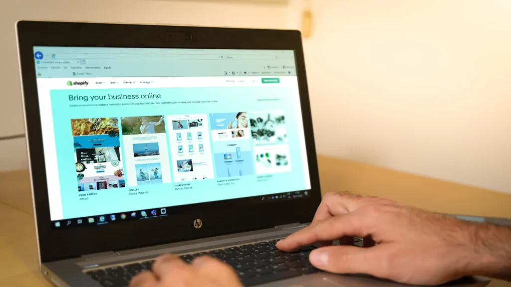 Shopify ecommerce website templates displayed on a laptop during online store setup