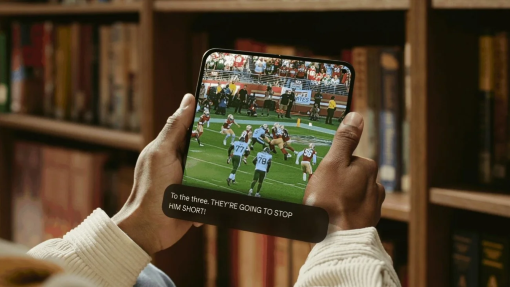 Person watching a football game on a mobile device with YouTube’s new Expressive Captions displayed on screen, demonstrating AI-driven captions that enhance accessibility and support YouTube marketing performance.