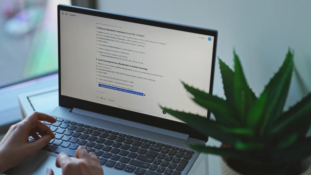 Marketer using generative AI tools on a laptop to support enterprise SEO strategy, content planning and AI-driven search optimisation