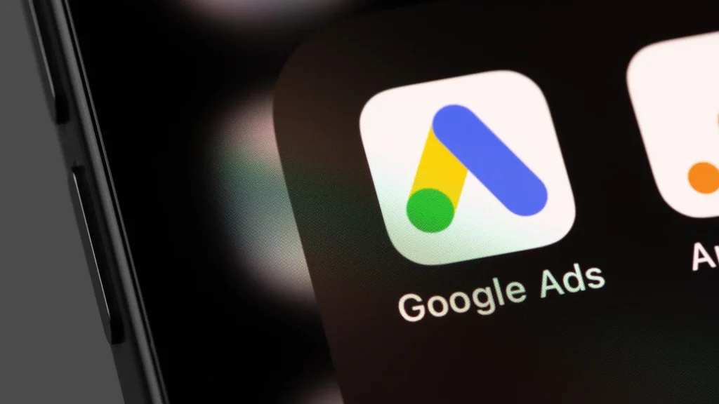 Close-up of the Google Ads app icon representing Google Ads Data Manager suggesting smart product connections such as GA4 and Merchant Center to strengthen data signals and campaign optimisation.