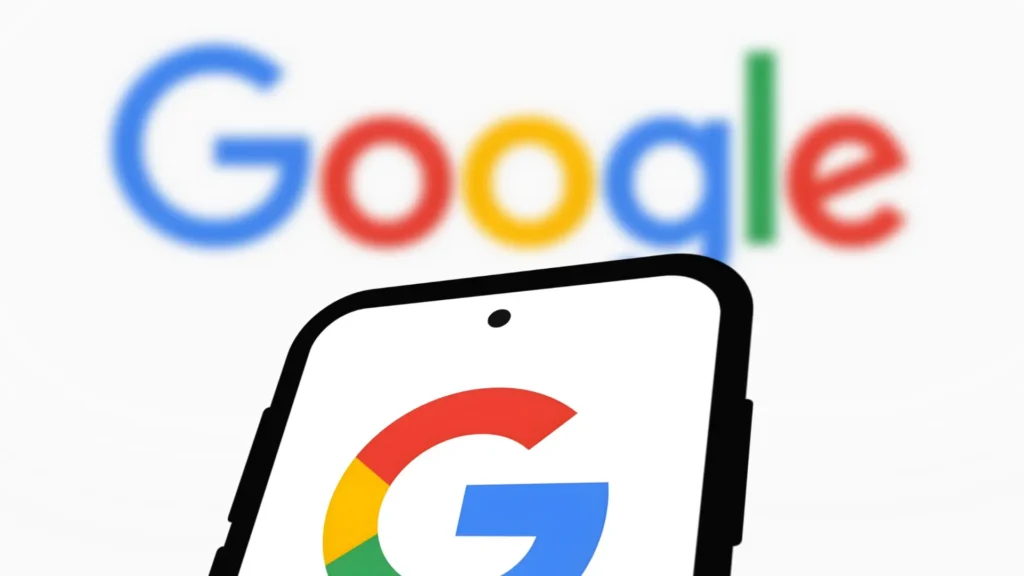 Smartphone displaying the Google logo in the foreground with a blurred Google wordmark behind it, representing Google Search and the rollout of a core algorithm update.