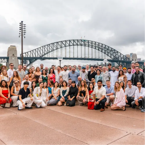 Claude responded: OMG Sydney team group photo in front of Sydney Harbour BridgeOMG Sydney team group photo in front of Sydney Harbour Bridge