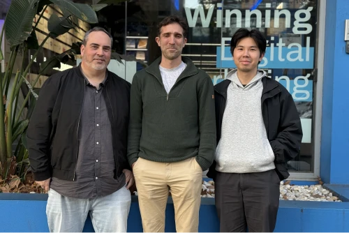 Three members of the Online Marketing Gurus web design and development team standing together outside the agency's Sydney office