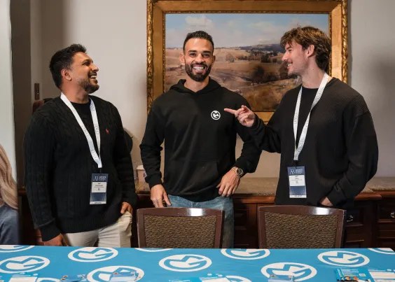Andrew, Saf and Liam from OMG networking at an industry conference