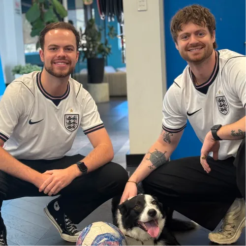 Dan and Adam in England football shirts with the office dog at OMG Sydney