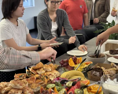 OMG team serving themselves from a breakfast spread in the Sydney office