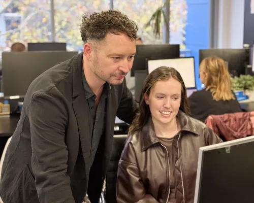 An OMG paid media strategist reviewing a meta campaign structured around product margin with a team member