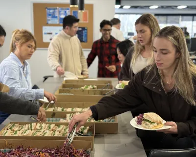 OMG team helping themselves to catered lunch in the Sydney office