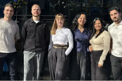 Six members of the Online Marketing Gurus SEO team standing together outside of Omg Sydney office
