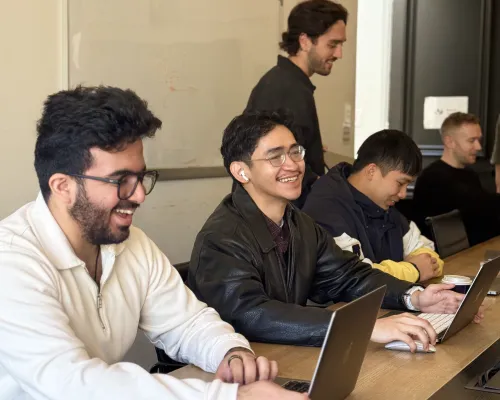 OMG paid media specialists collaborating on YouTube and video ad campaigns at their laptops in the office