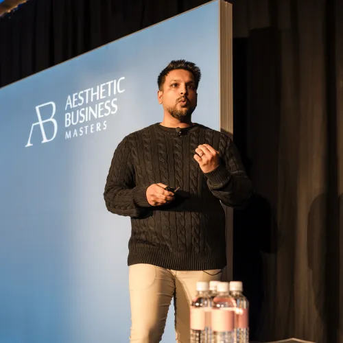 Saf, OMG Chief Growth Officer, presenting on stage at Aesthetic Business Masters Melbourne
