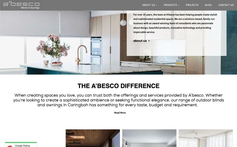 A'besco Blinds and Awnings homepage featuring a modern kitchen with a light roller blind over the window